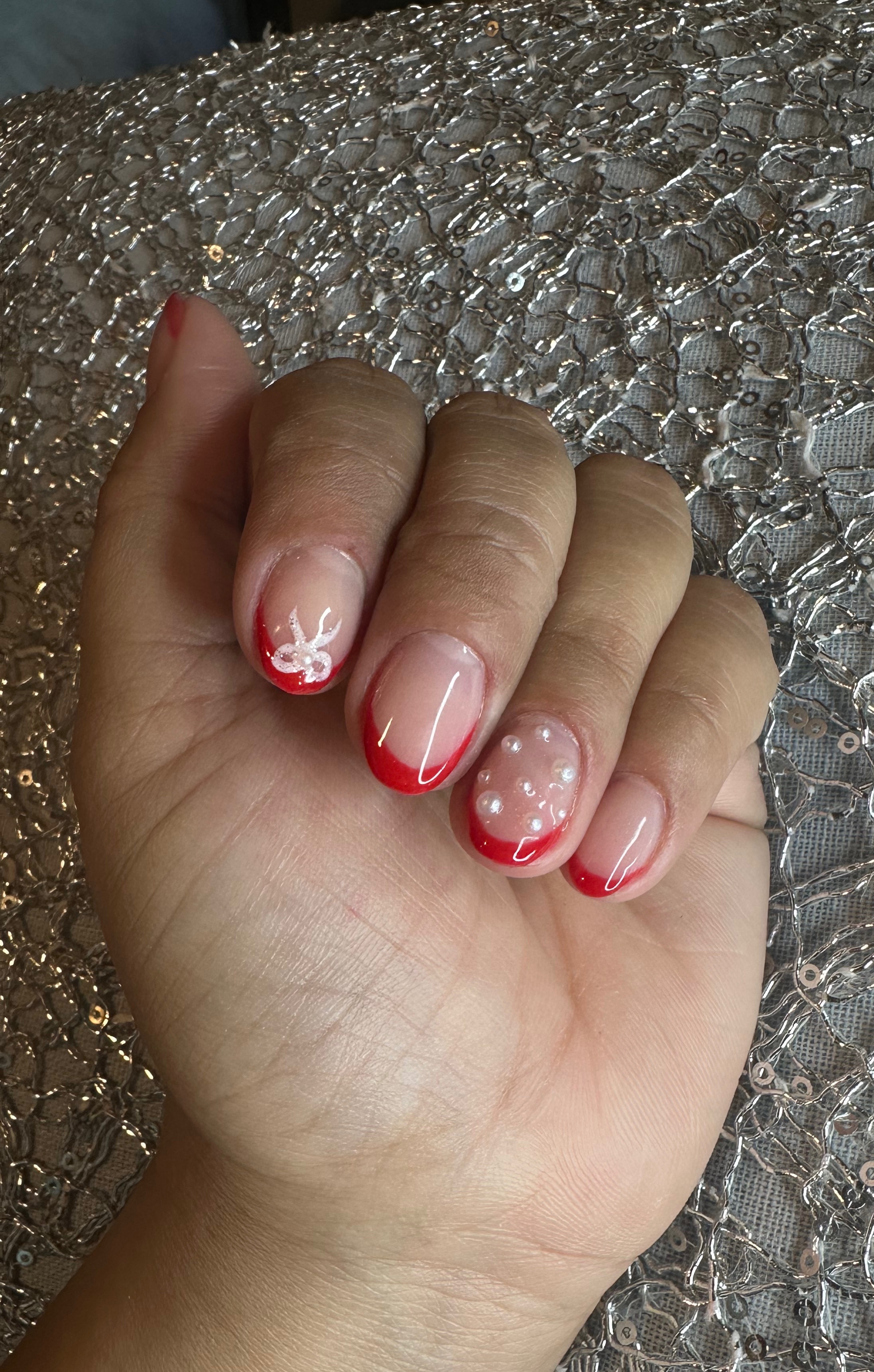 Acrylic french nail manicure with pearls.